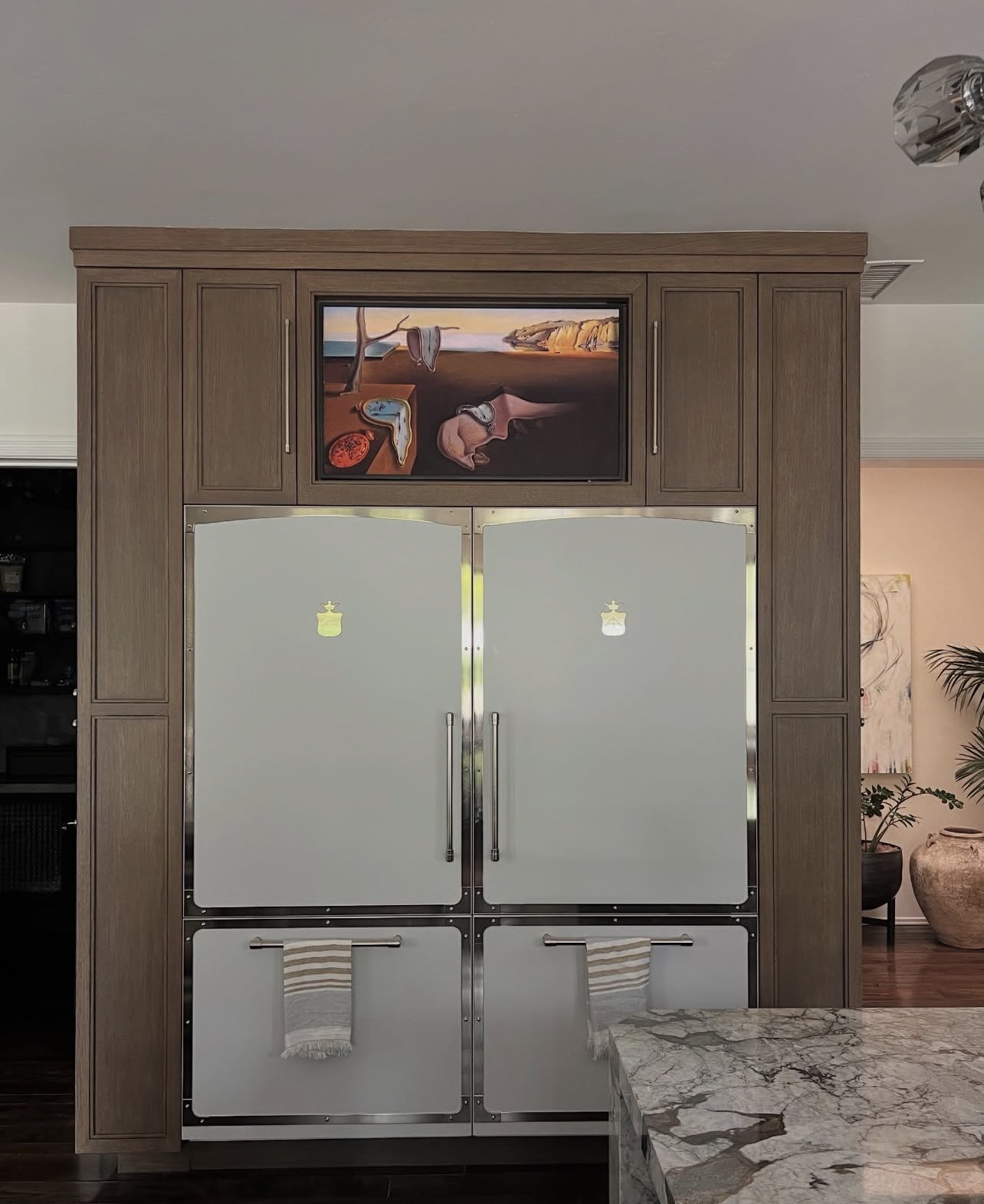 Samsung Frame TV installed in a custom cabinet above a refrigerator