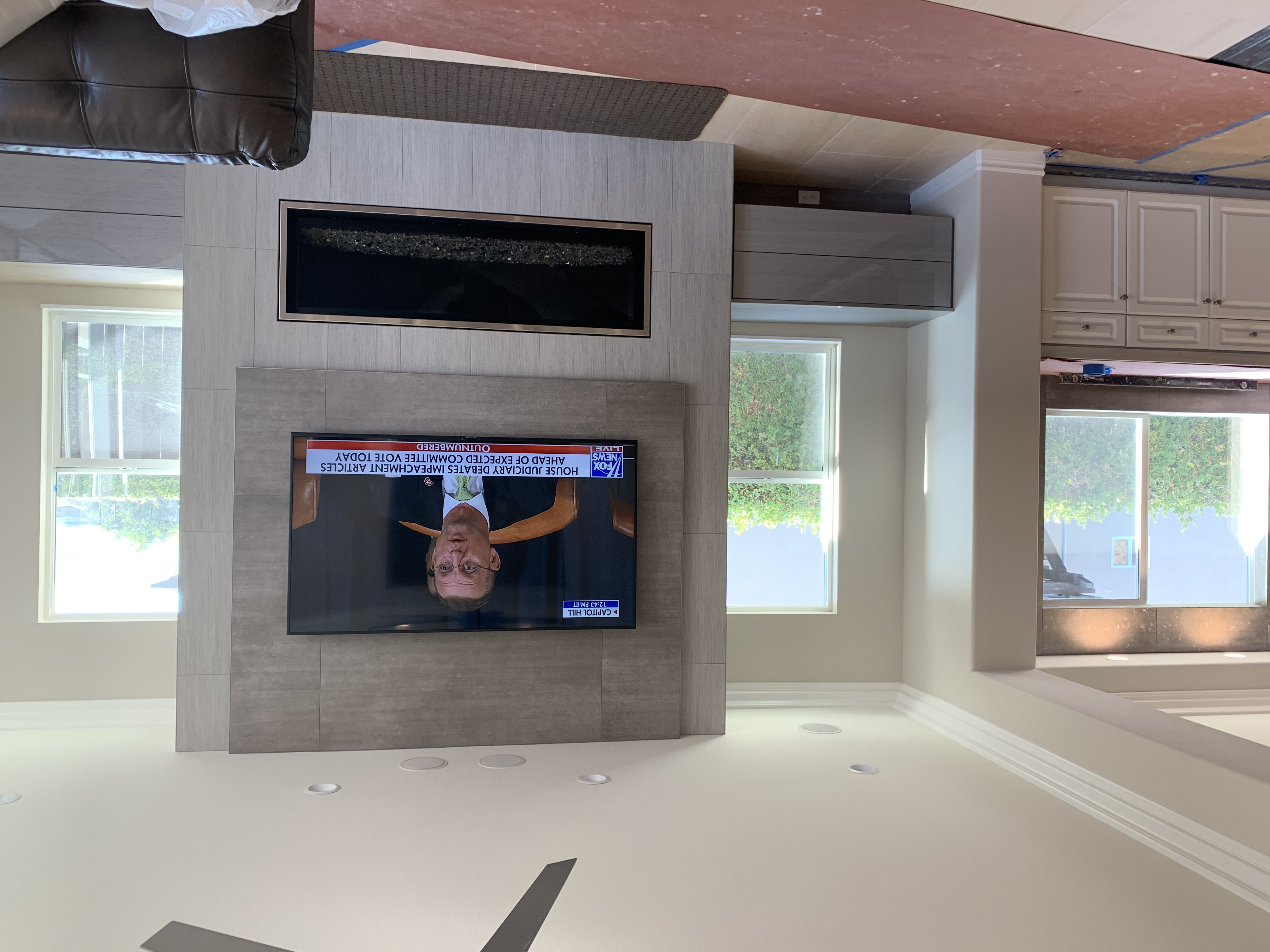 TV mounted above a modern fireplace