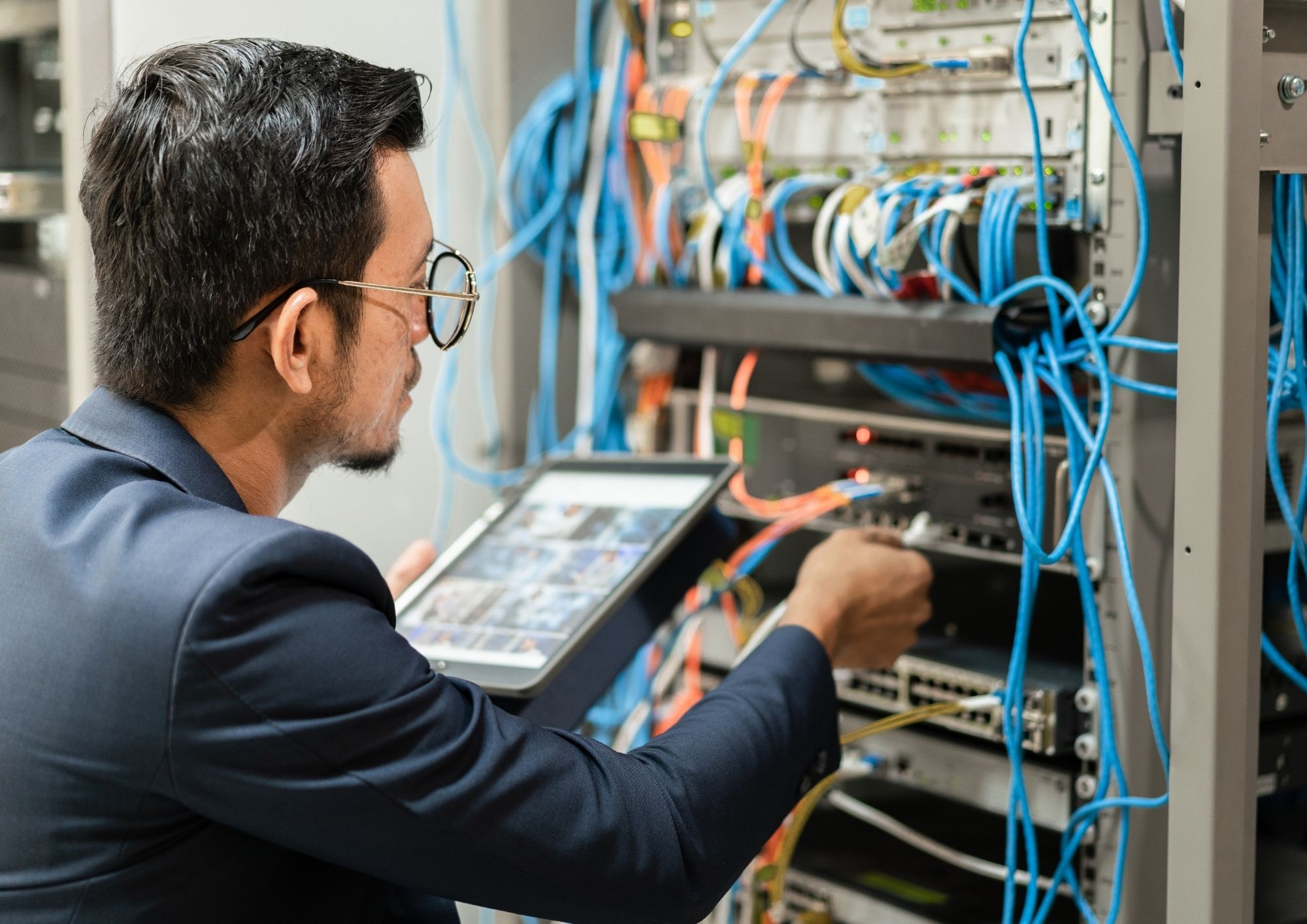 Network technician testing and commissioning structured cabling in a New York City office