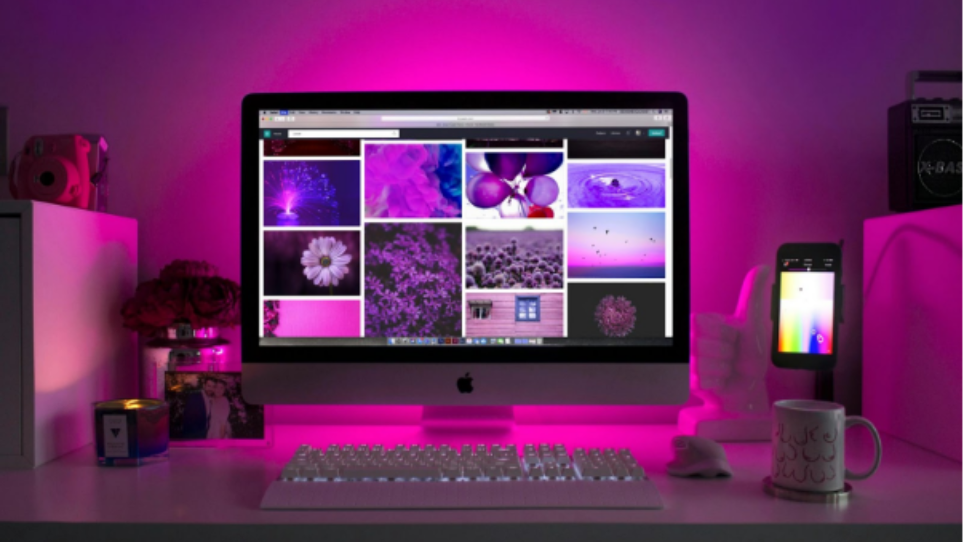 Desktop computer in a home studio with pink and purple lighting, displaying a visual gallery template for a music website design. Desktop computer in a home studio with pink and purple lighting, displaying a visual gallery template for a music website design.
