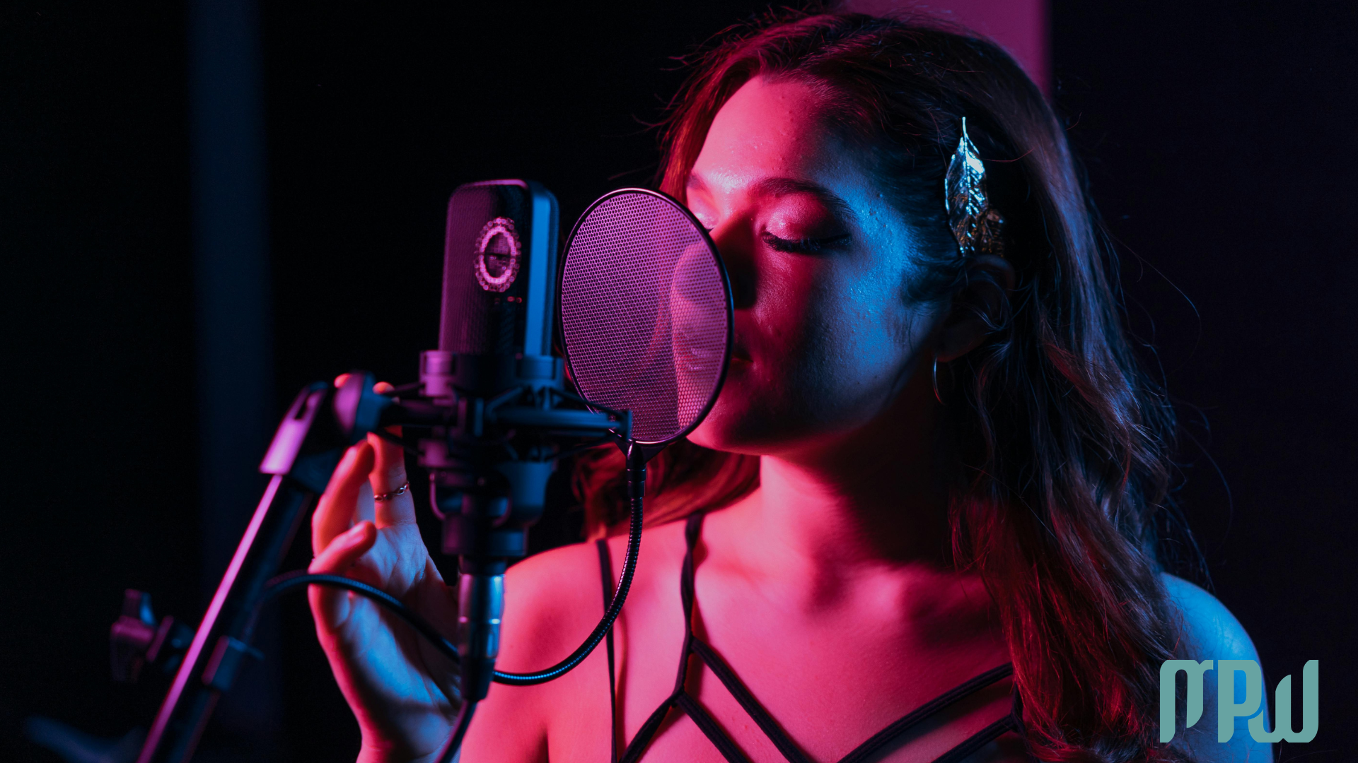 Singer recording vocals with headphones and microphone in a home studioSinger recording vocals with headphones and microphone in a home studio