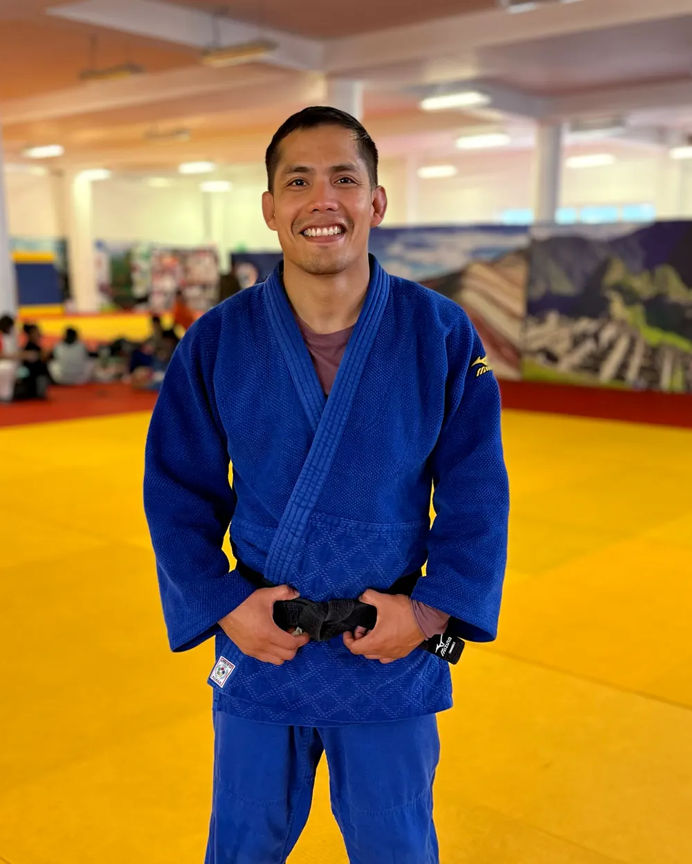 Coach Jhonatan Gutierrez in a blue judo gi