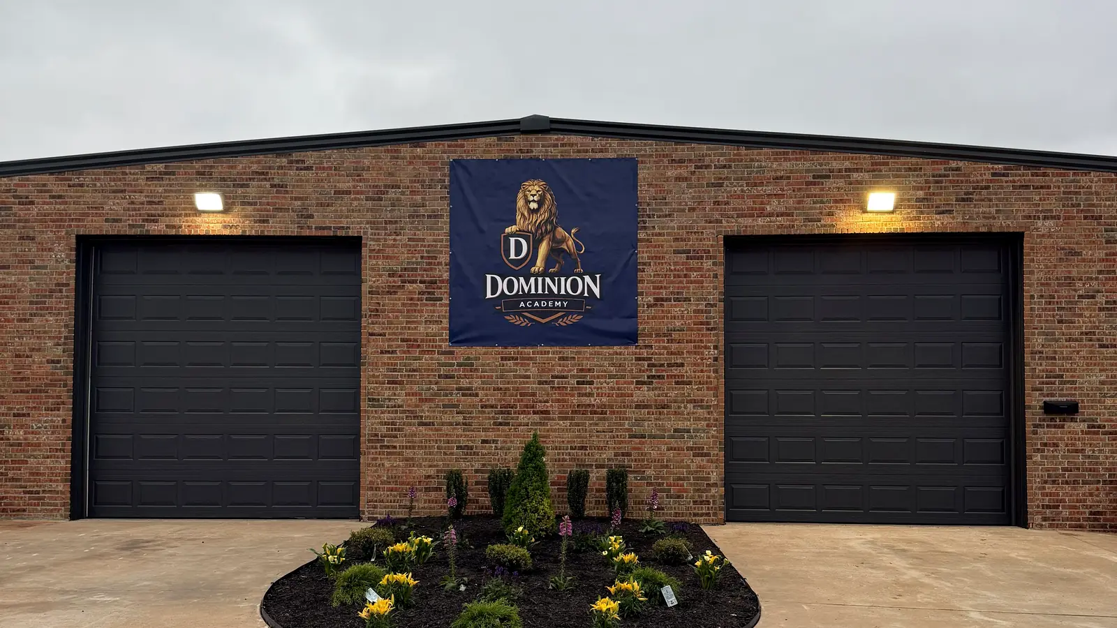 Dominion Academy building with the lion logo banner on East Highline Lane in Mustang