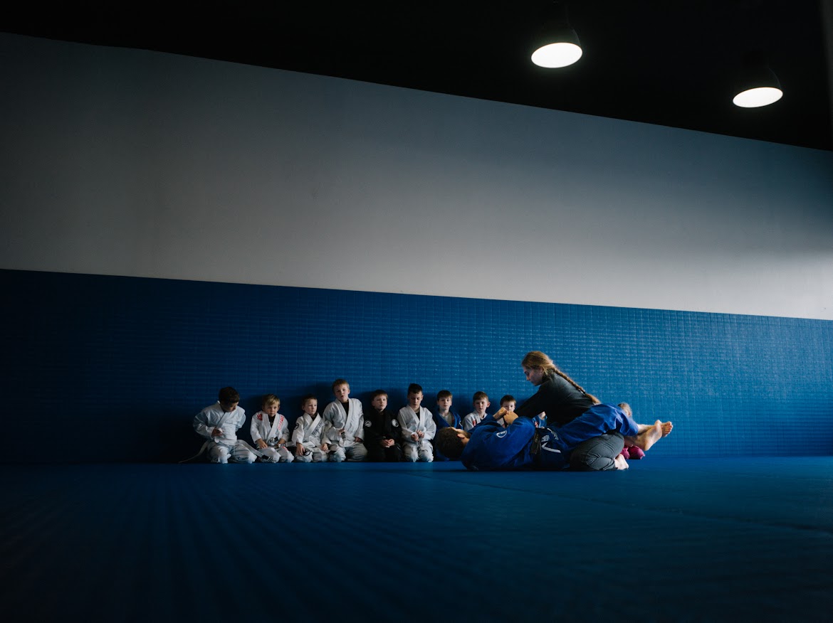 Jiu Jitsu professor Markus demonstrates a technique with bjj brown belt charlotte