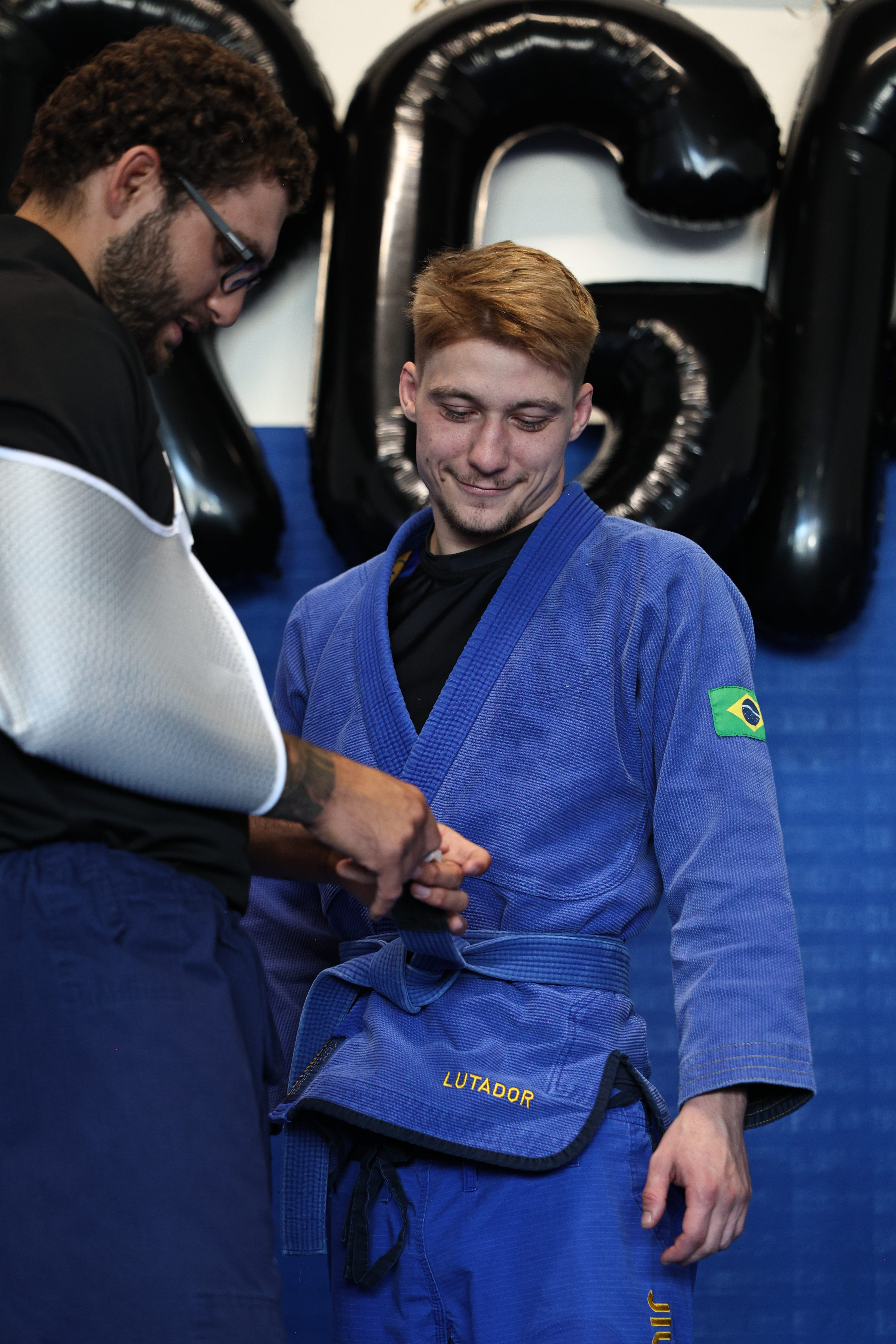 student receiving bjj promotion student receiving bjj promotion