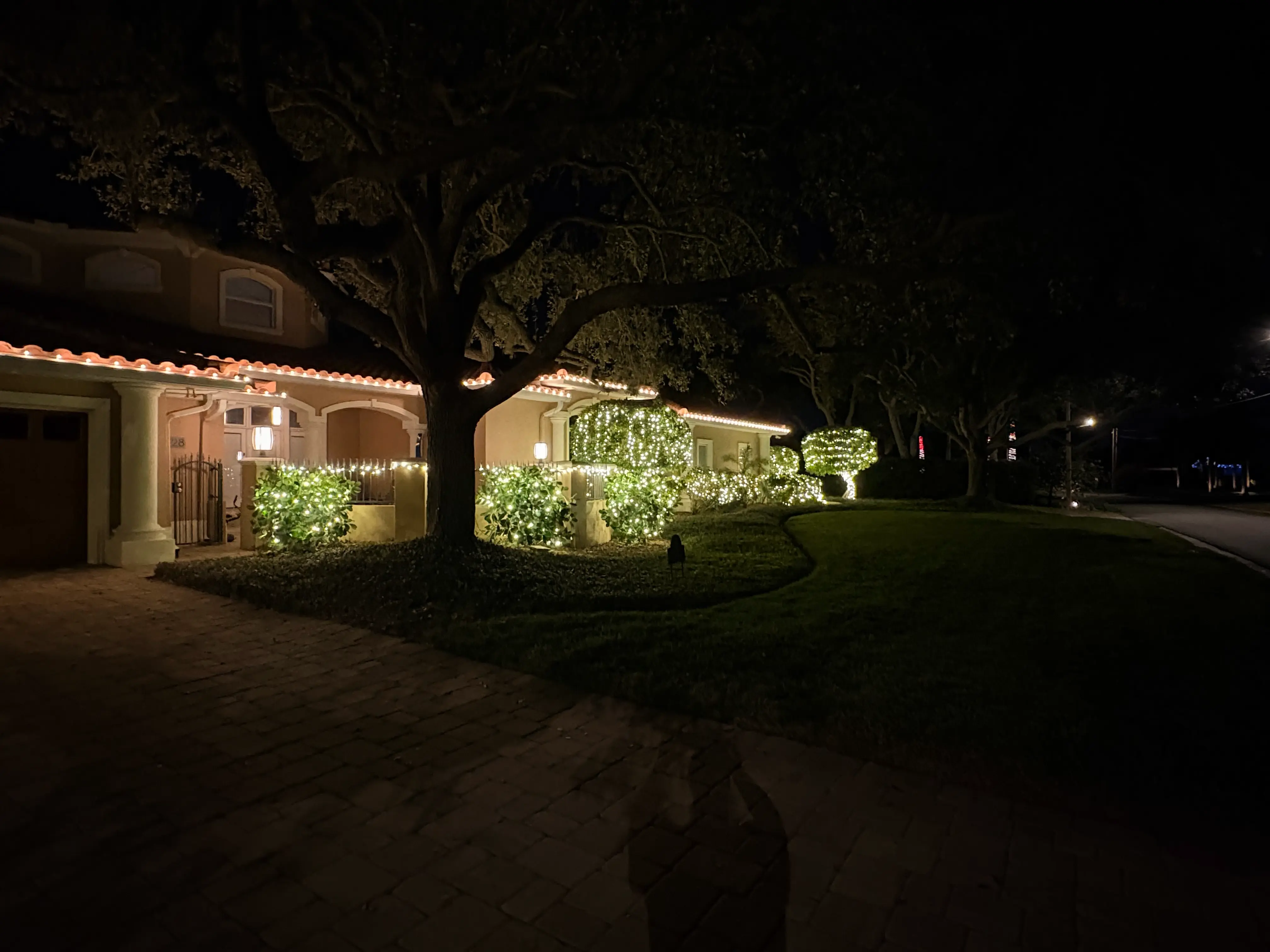 Professionally installed warm white holiday lights outlining a Florida home