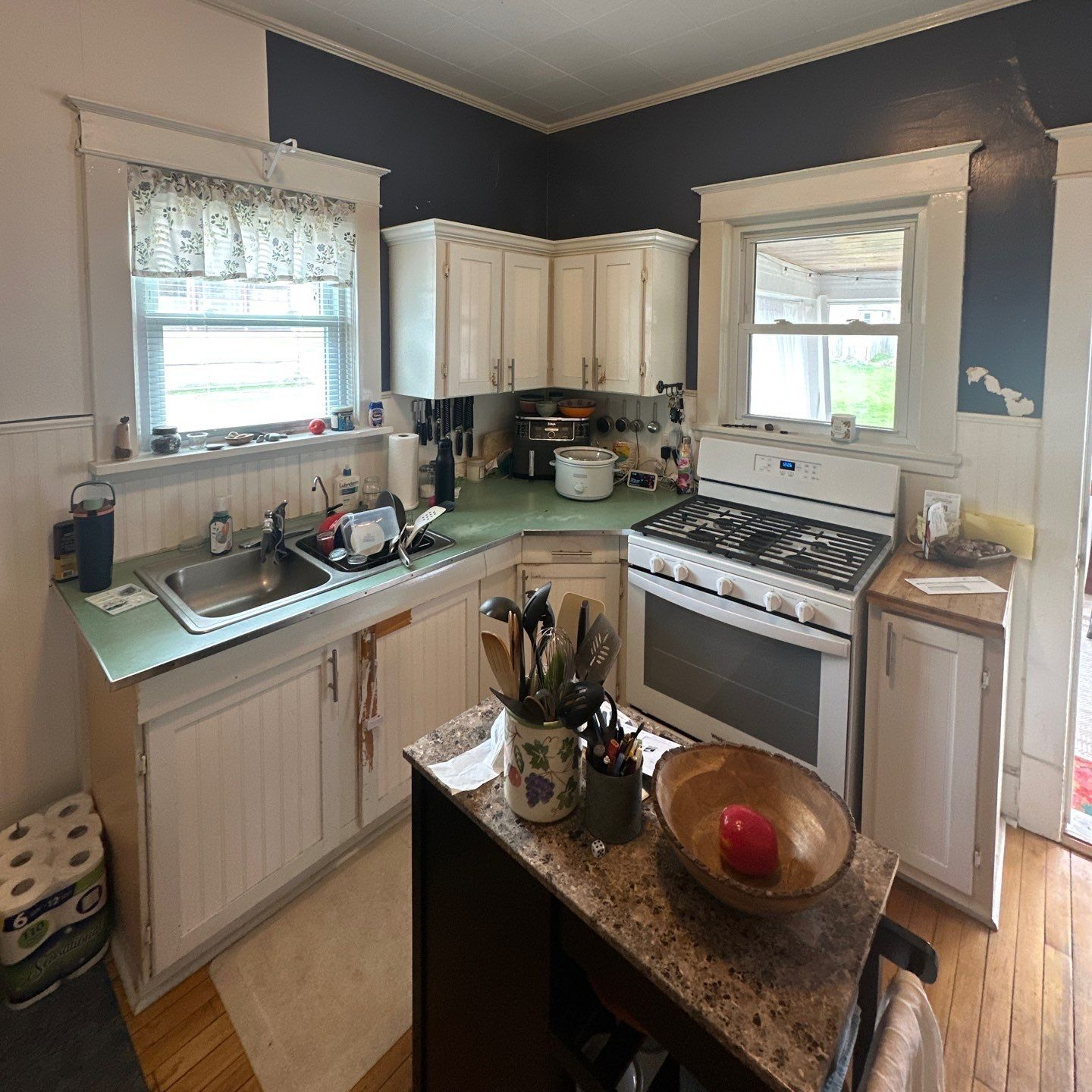Before — cramped dated kitchen with dark cabinets
