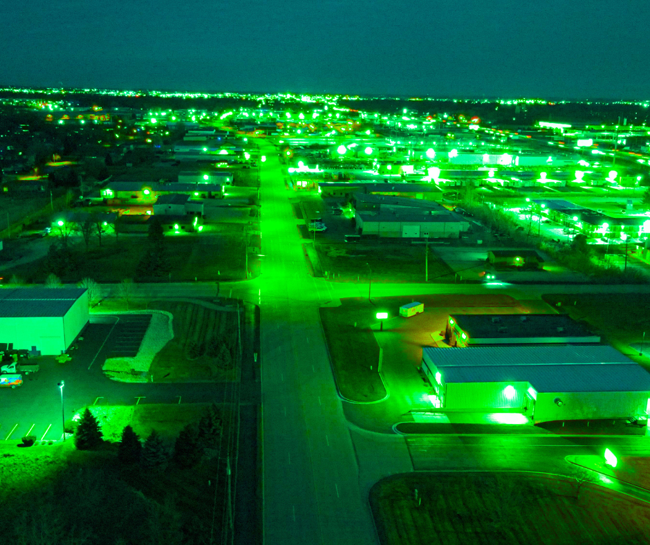 Town at night seen through night vision goggles, glowing green