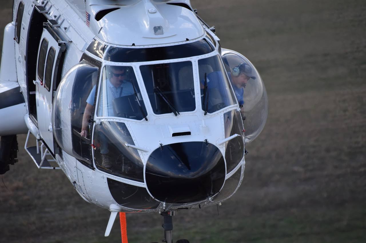 David Tappe piloting helicopter during aerial construction lift operation