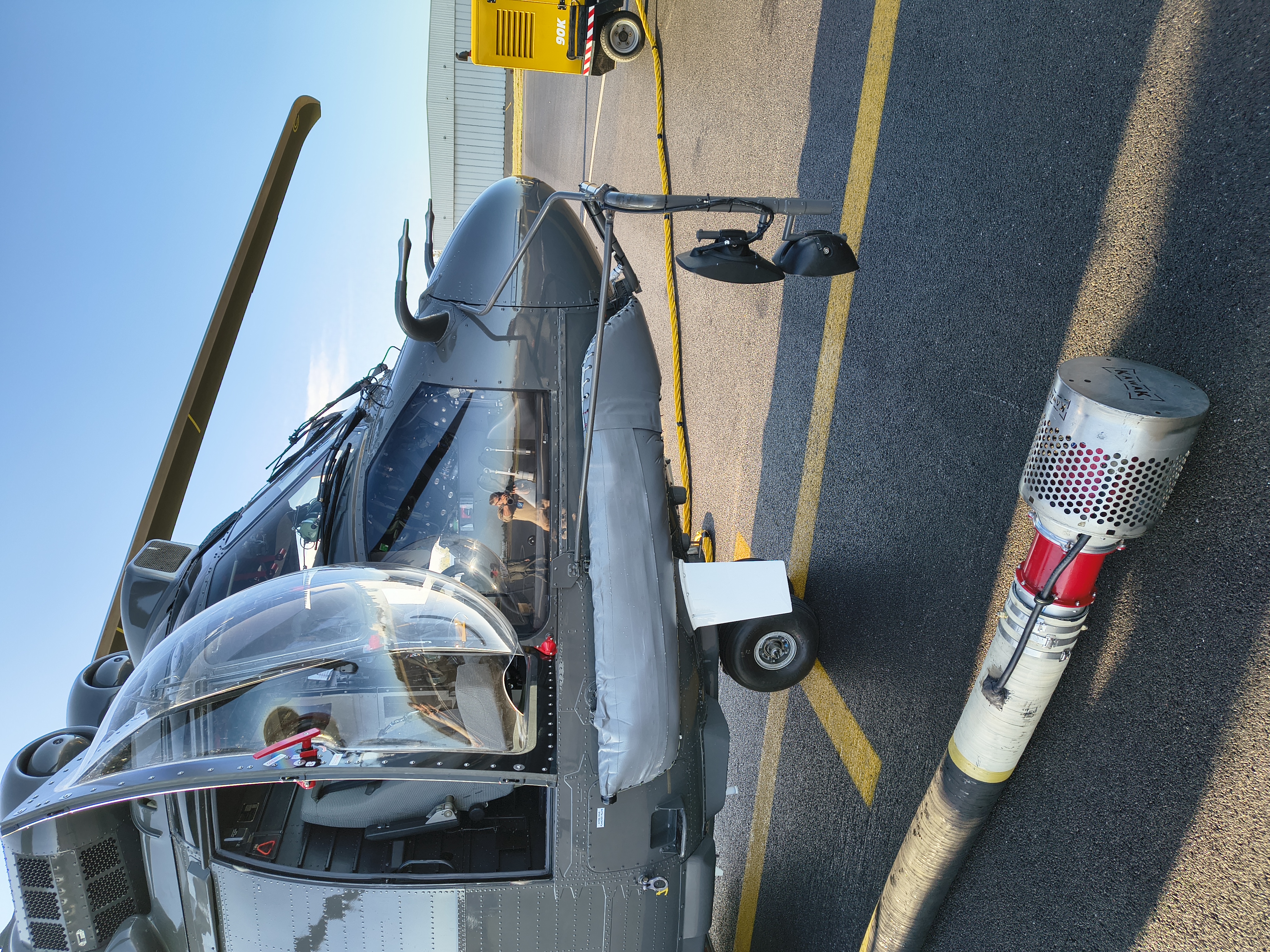 Helicopter equipped with water tank and snorkel system for aerial fire suppression