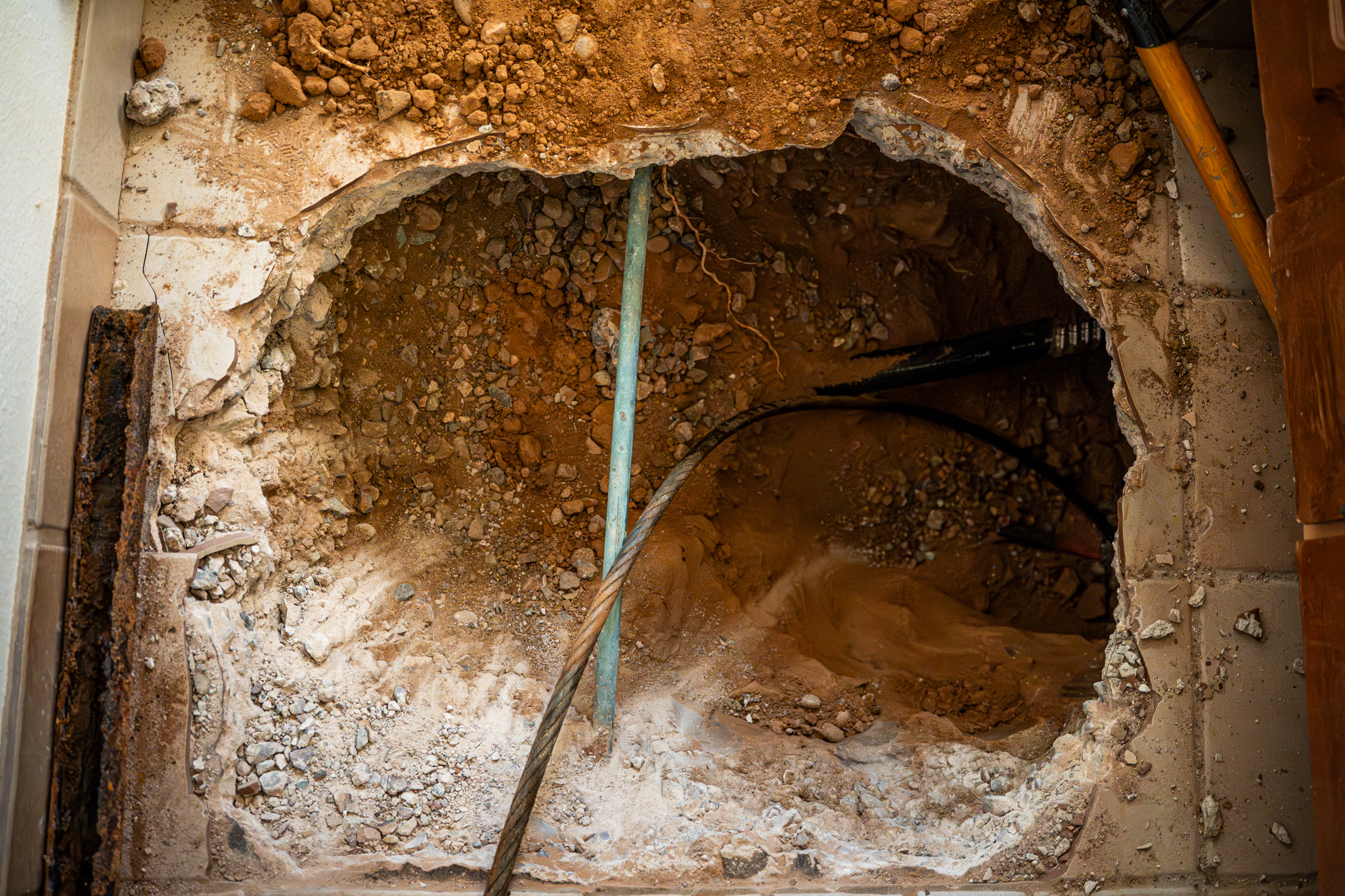 Hole dug for drain line inspection