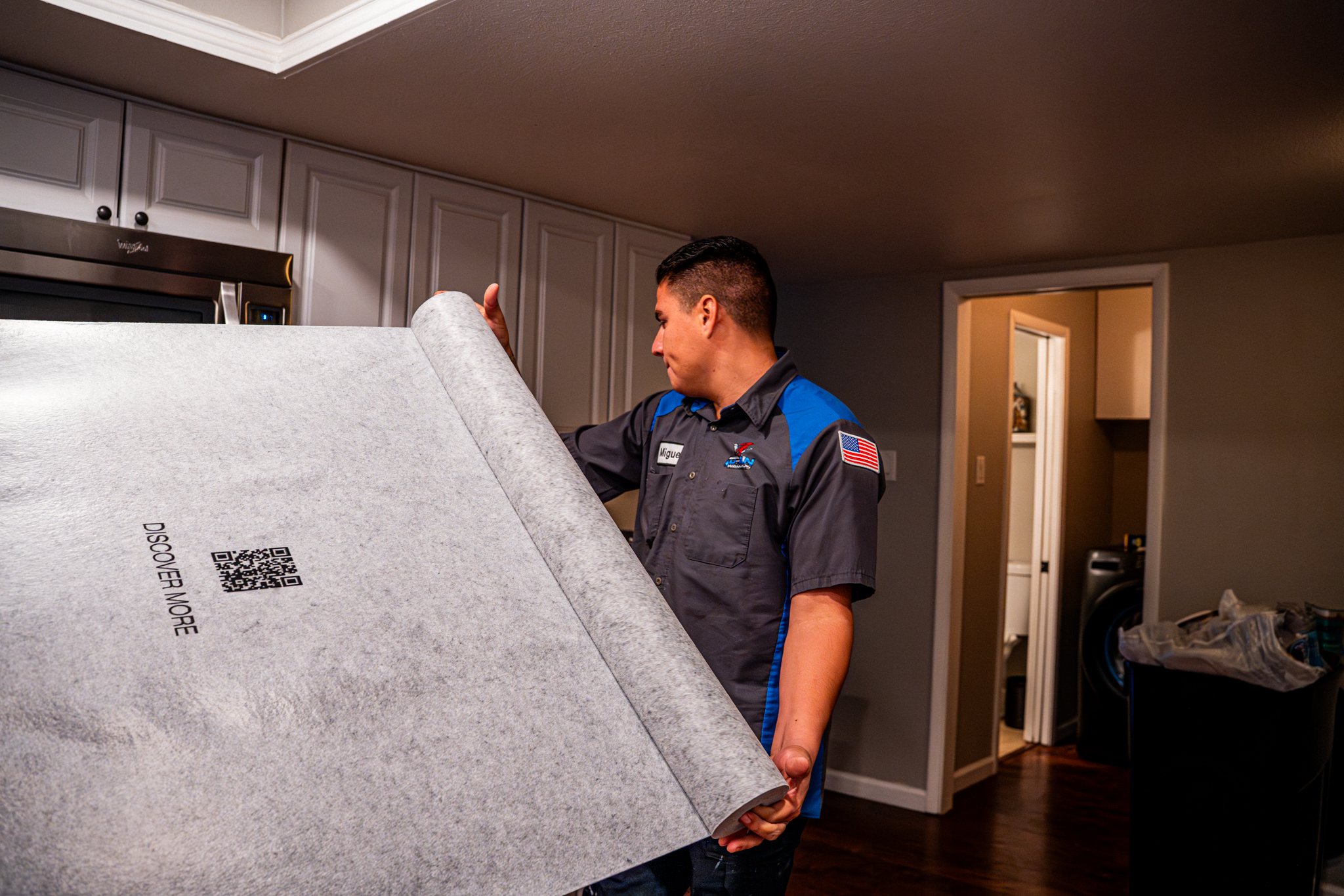Drain Warriors carrying flooring cover for clean work