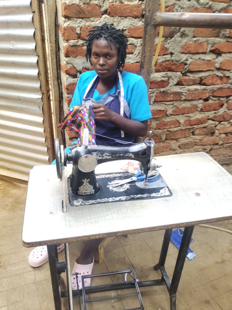 Student at sewing machine in Uganda
