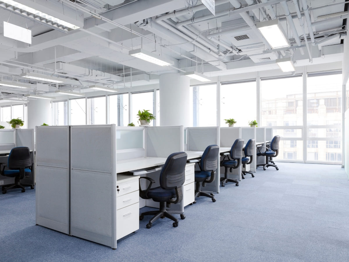 Well-organized office with cubicles, clean workstations, and natural light, highlighting comprehensive office cleaning and organization services in Napa.