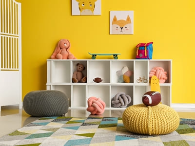 Colorful children’s playroom with organized shelves and plush toys, ideal for a vibrant, well-maintained environment.