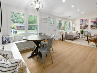 Bright, modern living area with a dining table and large windows, showcasing a clean and inviting space.