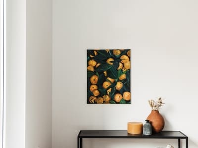 Minimalist interior featuring a clean, white painted wall with a still-life painting and decorative items on a black console table.