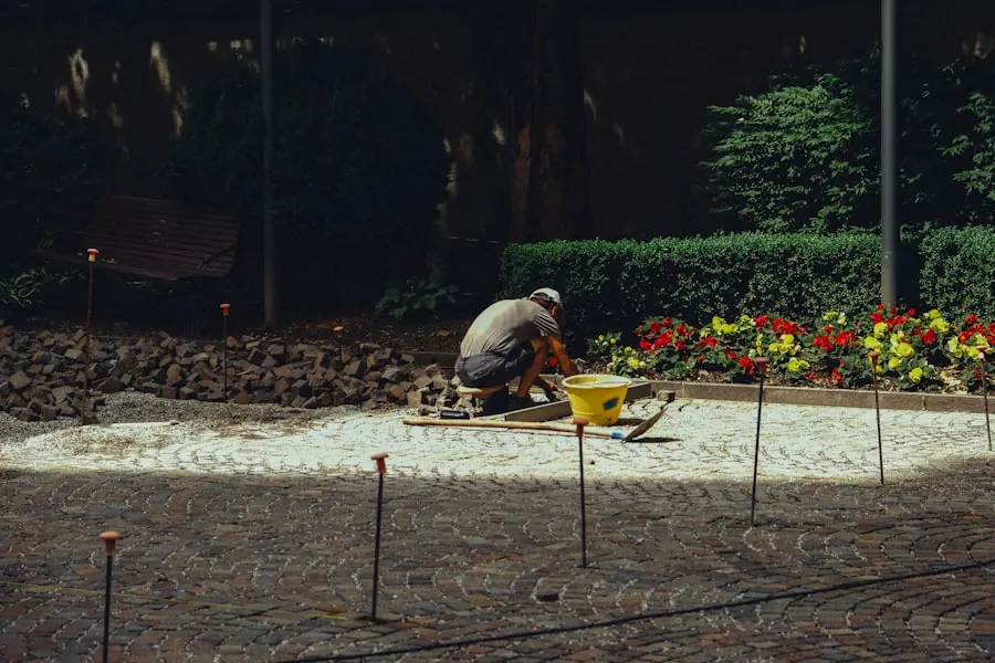 Gardener laying stones in a flower bed during a landscape install