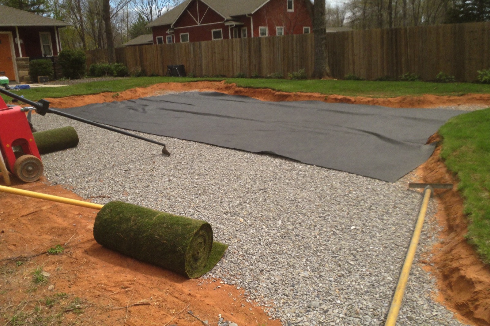 Geotextile fabric and compacted crushed-stone base over excavated North Carolina red clay