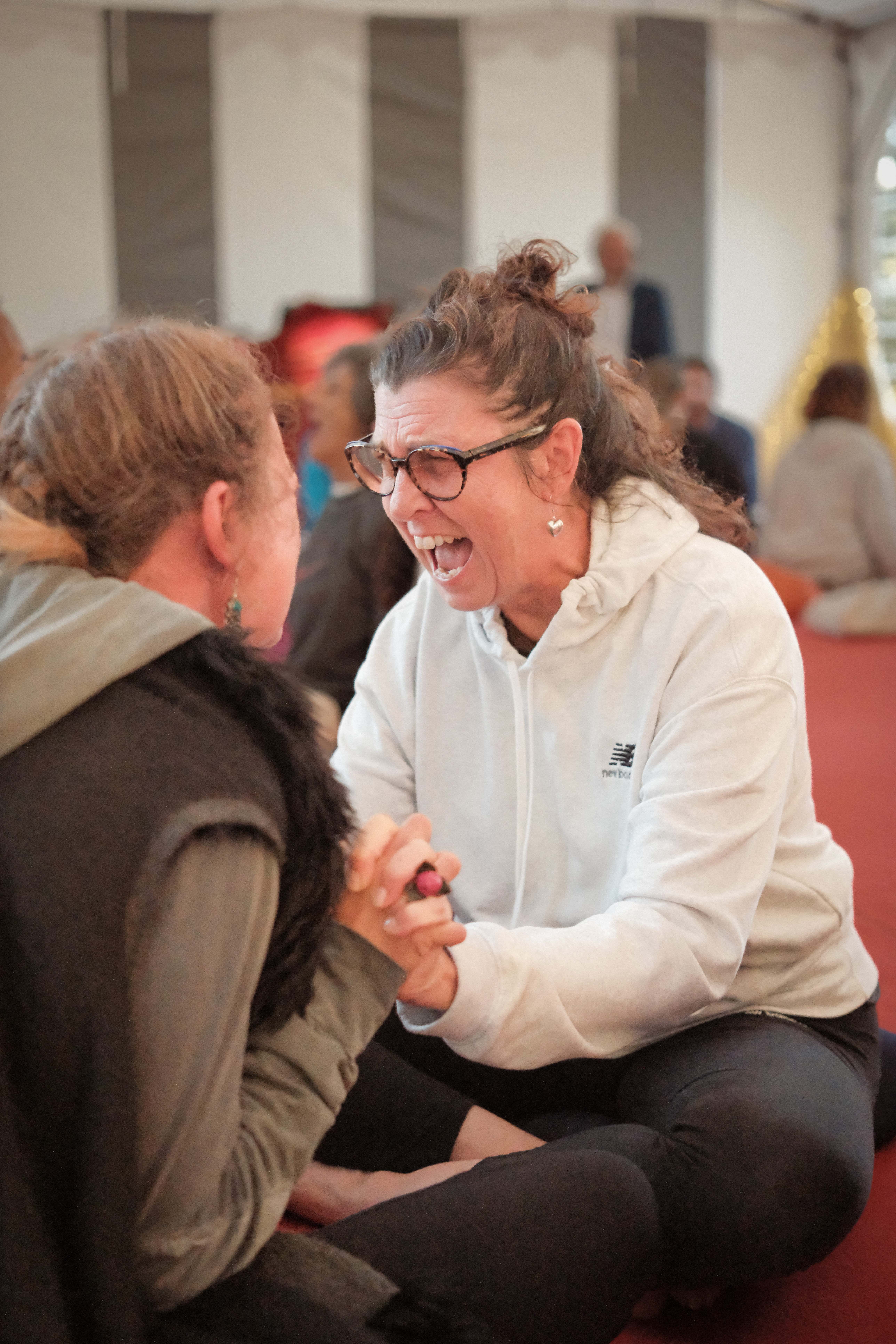 A breathwork participant in deep emotional release during a session