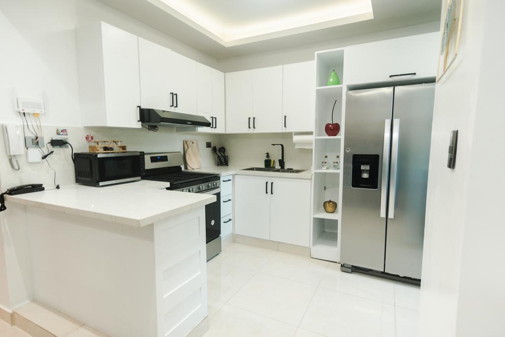 White kitchen with stainless steel appliances