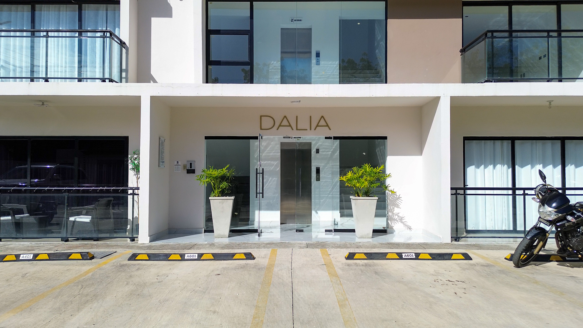 Exterior of the Dalia apartment building with glass balconies