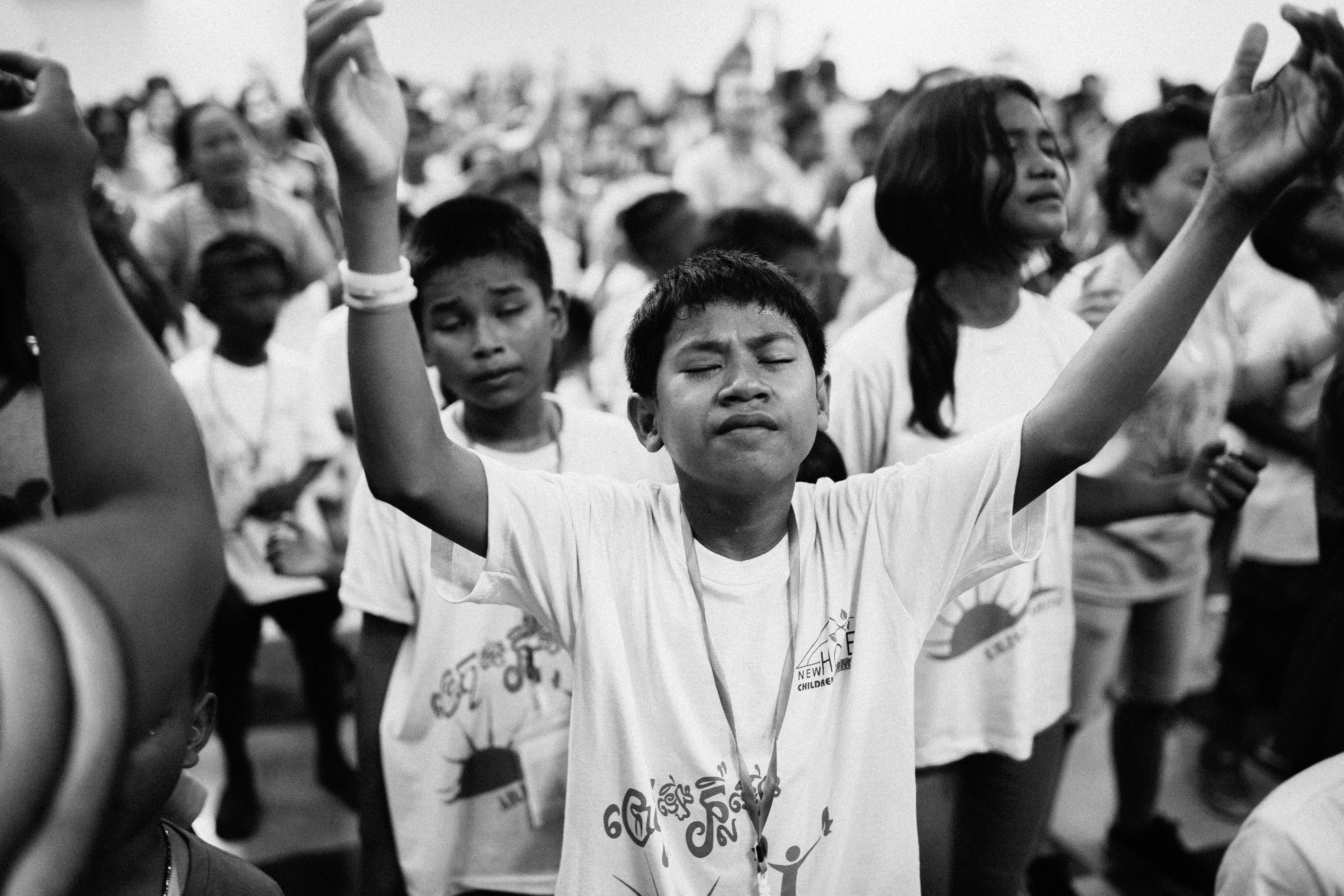 Child in worship at camp