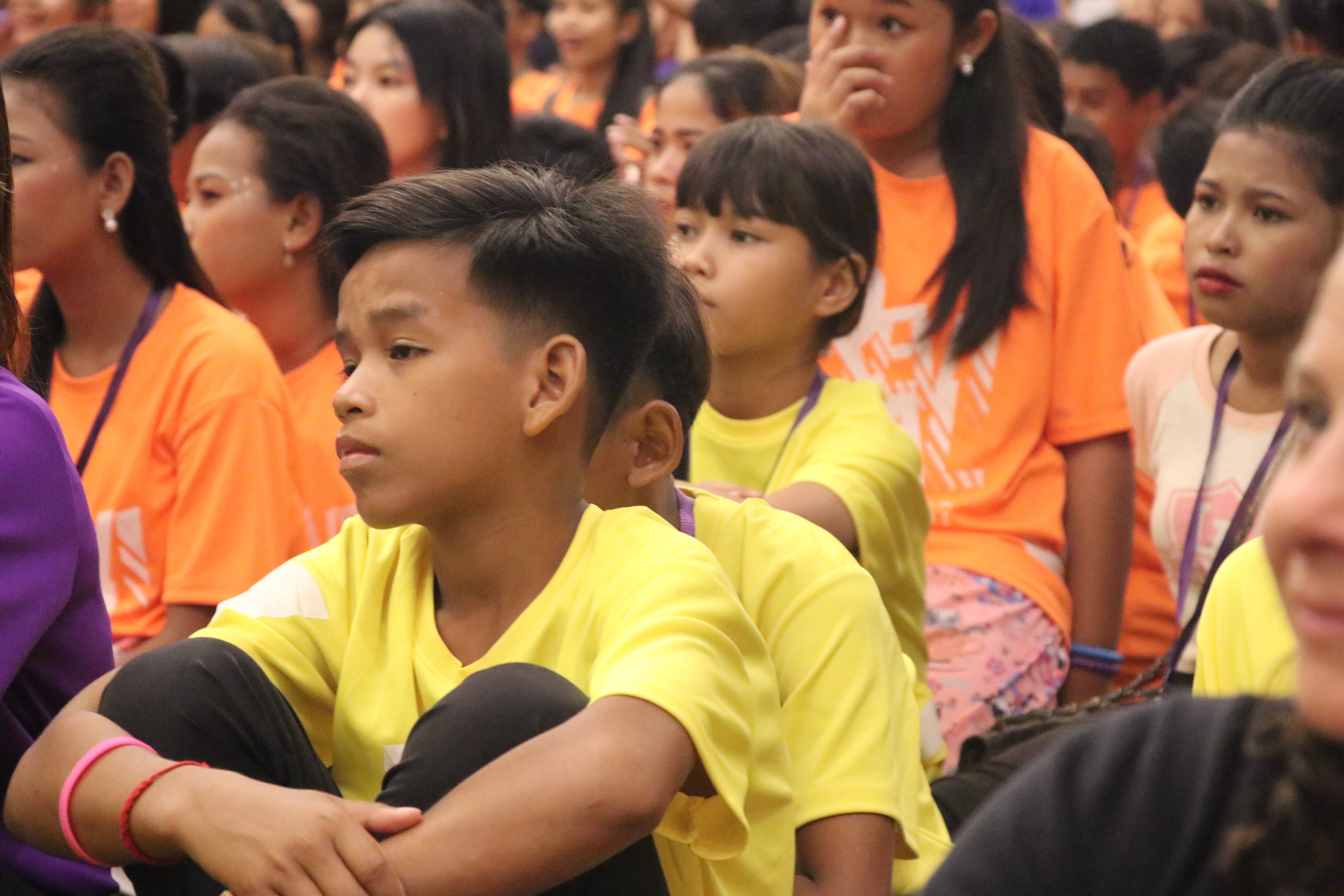 Children listening intently at camp