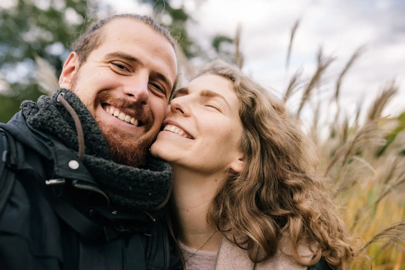 Two people smiling, cheek to cheek.
