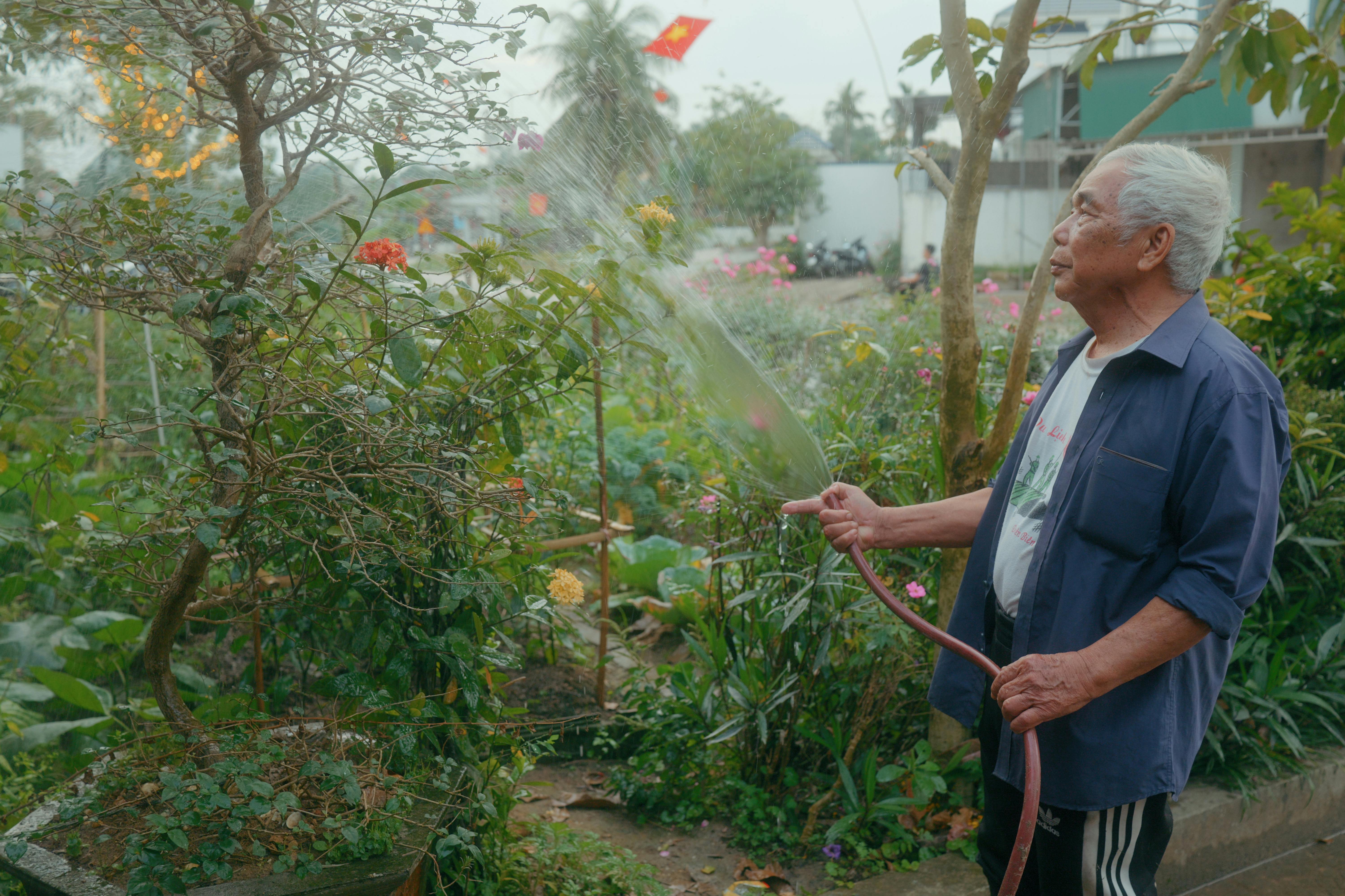 Senior man watering garden at home demonstrating independence with home care in Illinois
