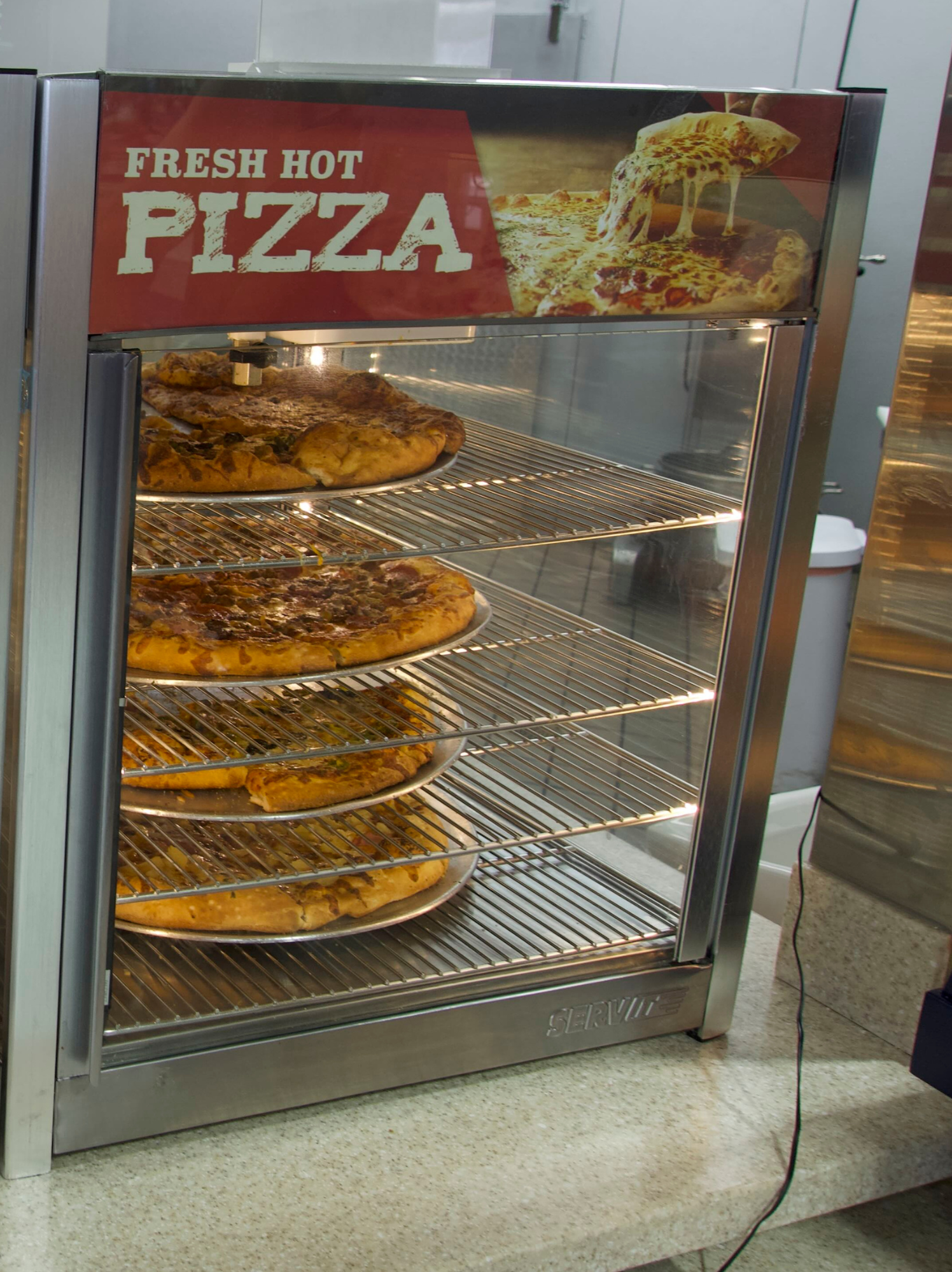 Fresh pizza slices and whole pies at SM Gas hot food station