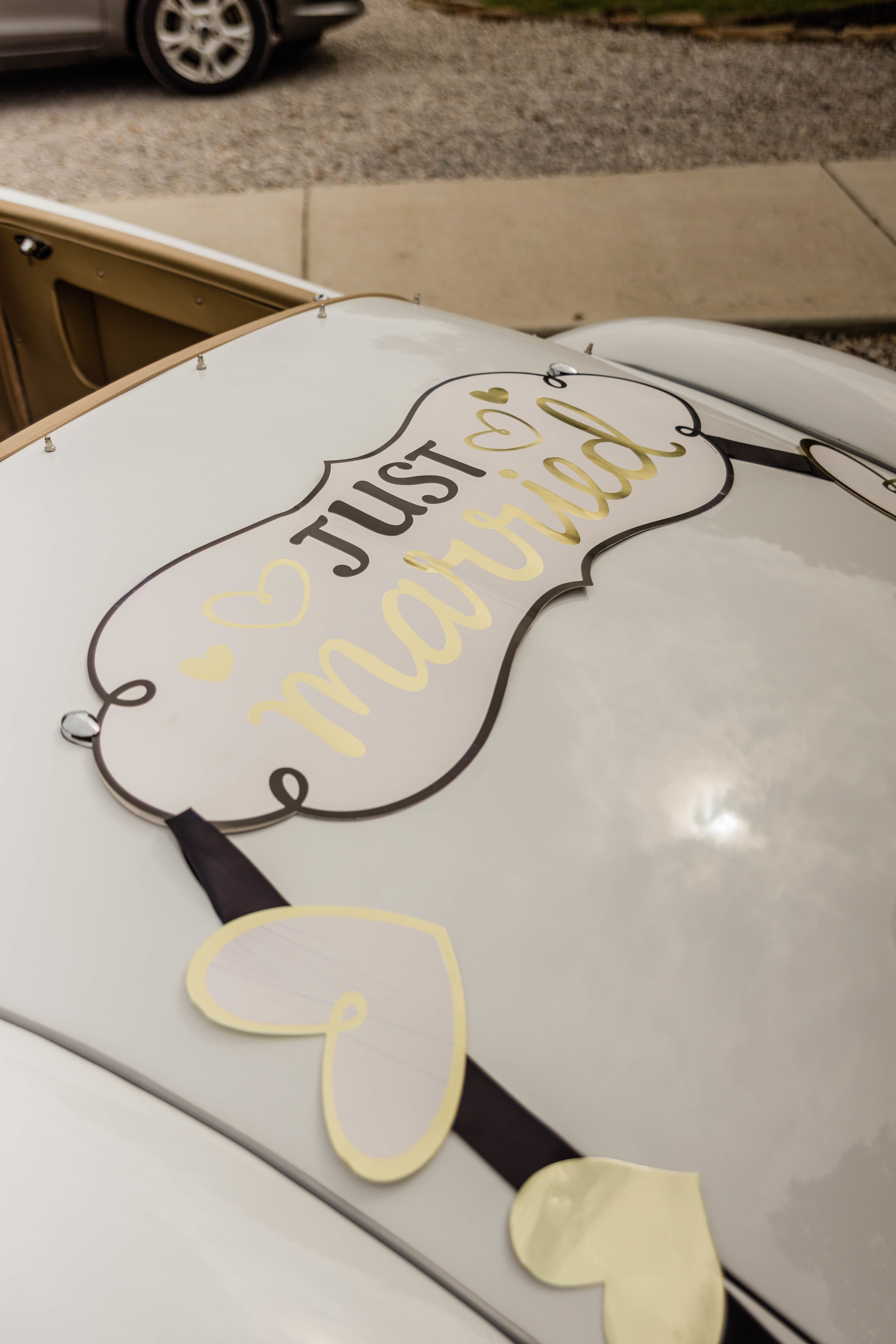 A Just Married sign on the back of the Getaway Car