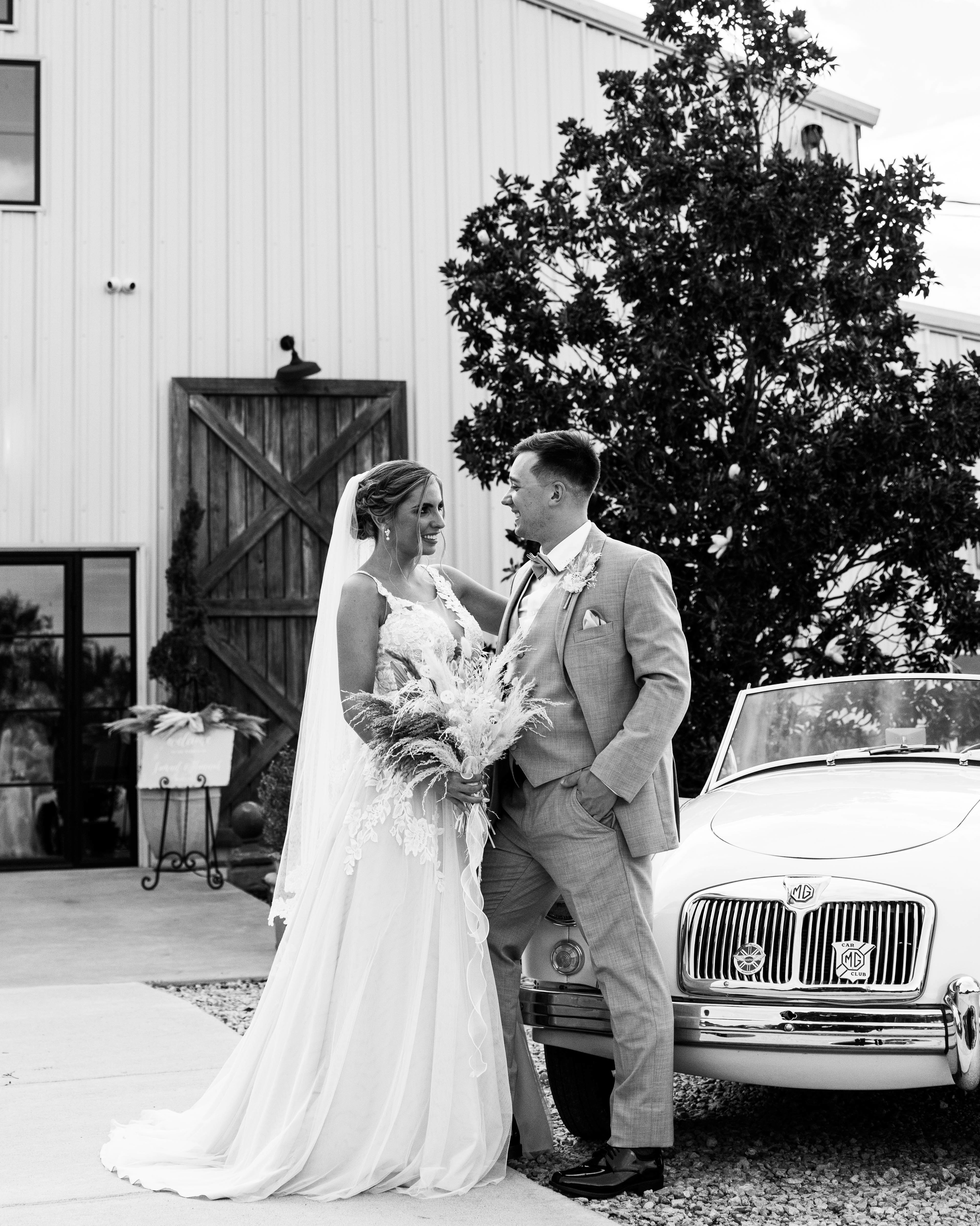 A newlywed couple with the Getaway Car at their wedding