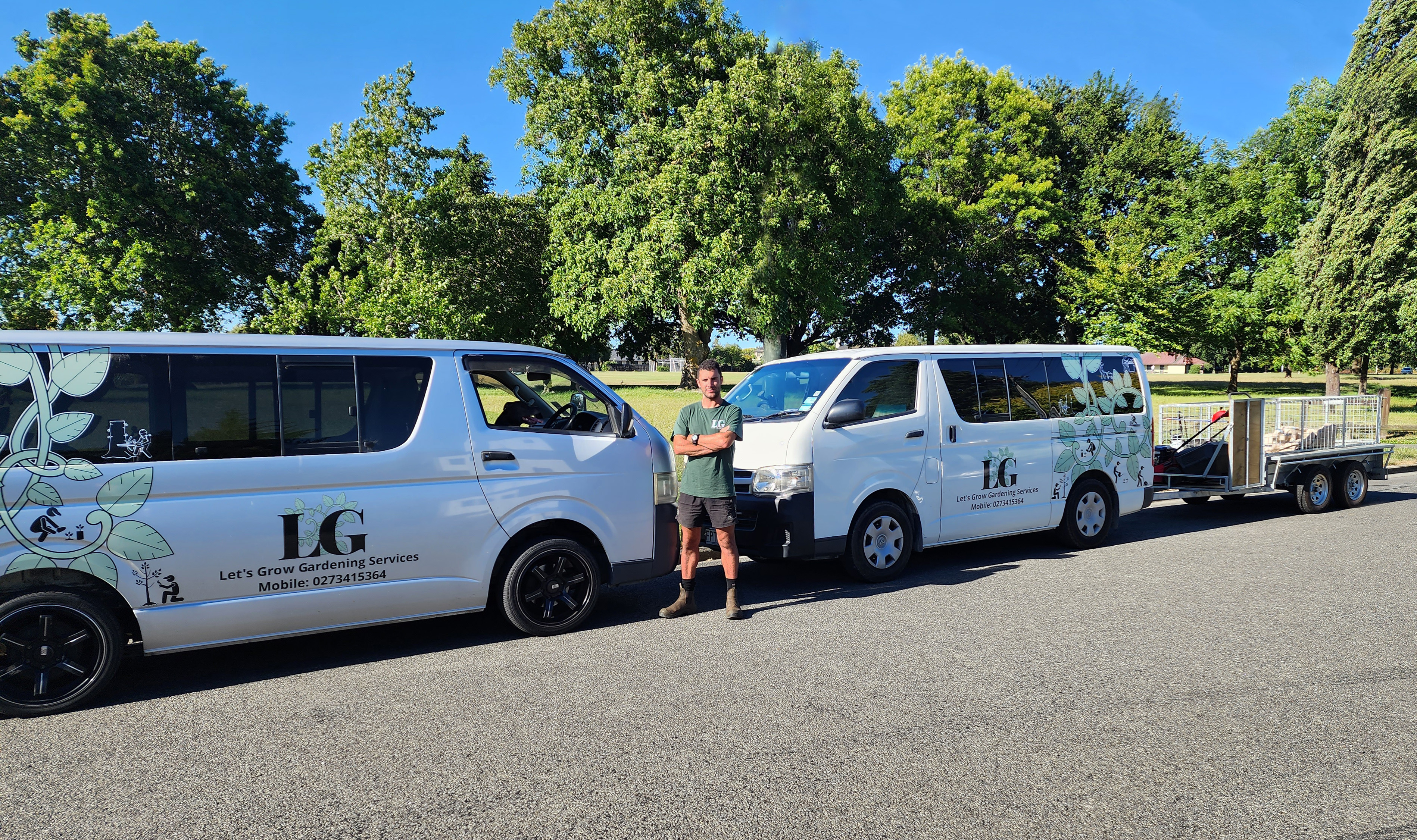 Glenn in front of Let's Grow Gardening branded vans