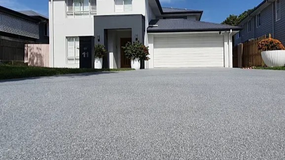 A white car in a garage with a finished floor