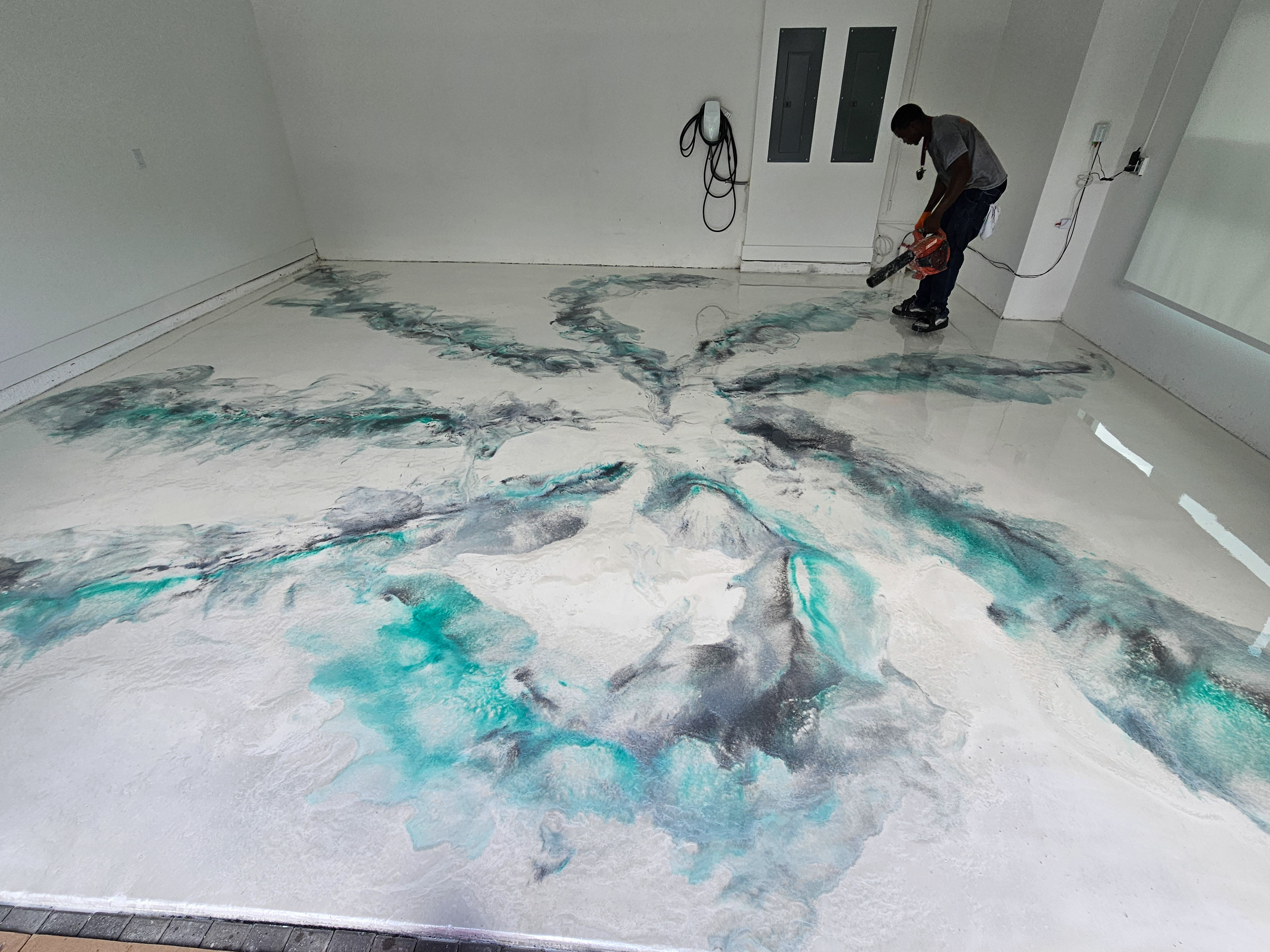 A white car in a garage with a finished floor