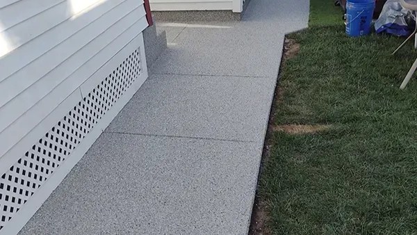 A white car in a garage with a finished floor