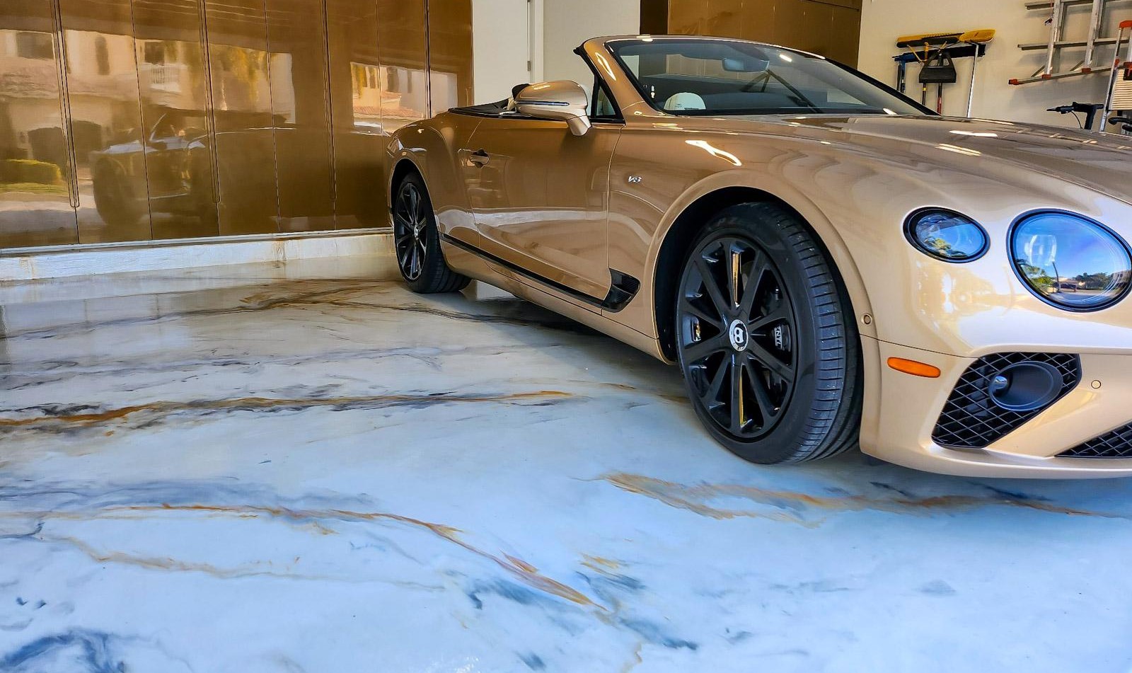 A white car in a garage with a finished floor