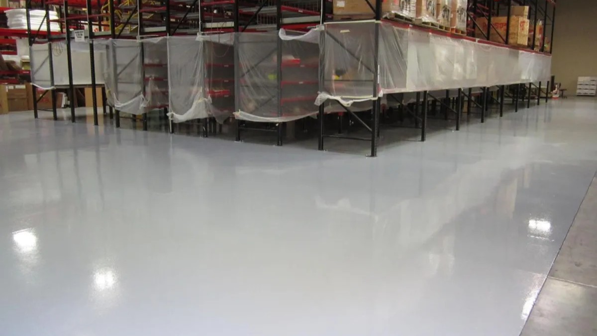 A white car in a garage with a finished floor