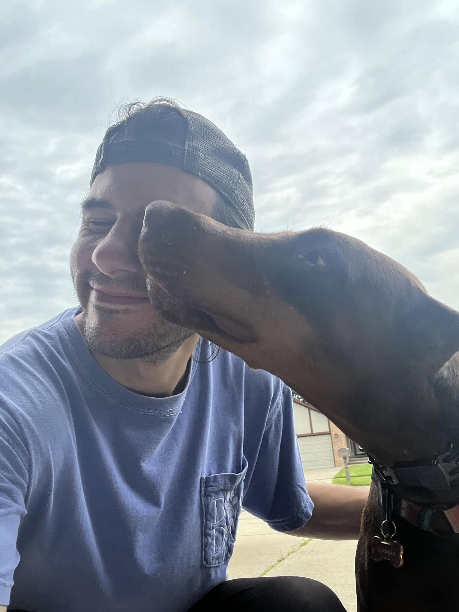 Trainer posing with client dog after session