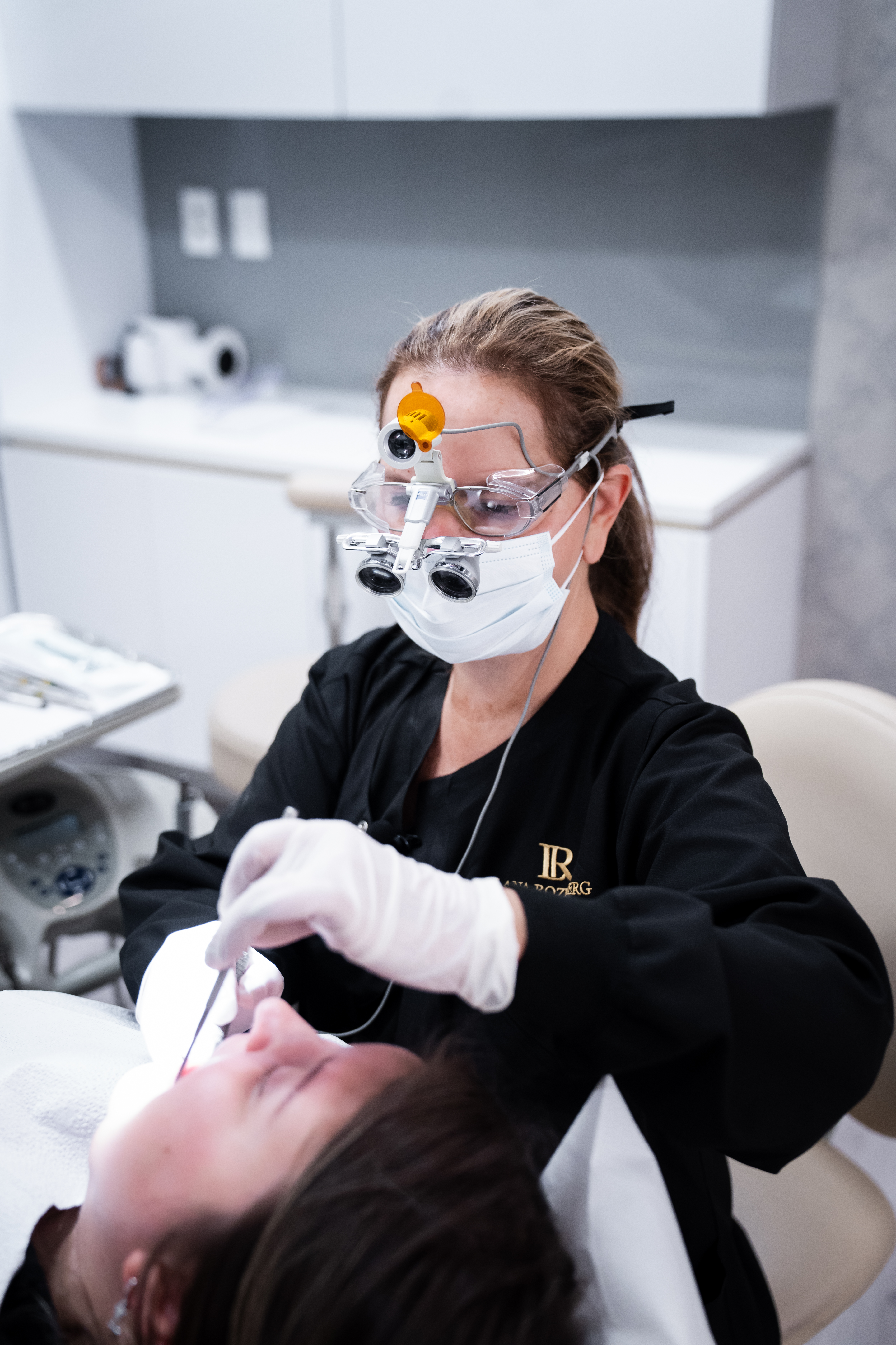 Dr. Lana Rozenberg, DDS providing care at her Midtown, NYC dental office