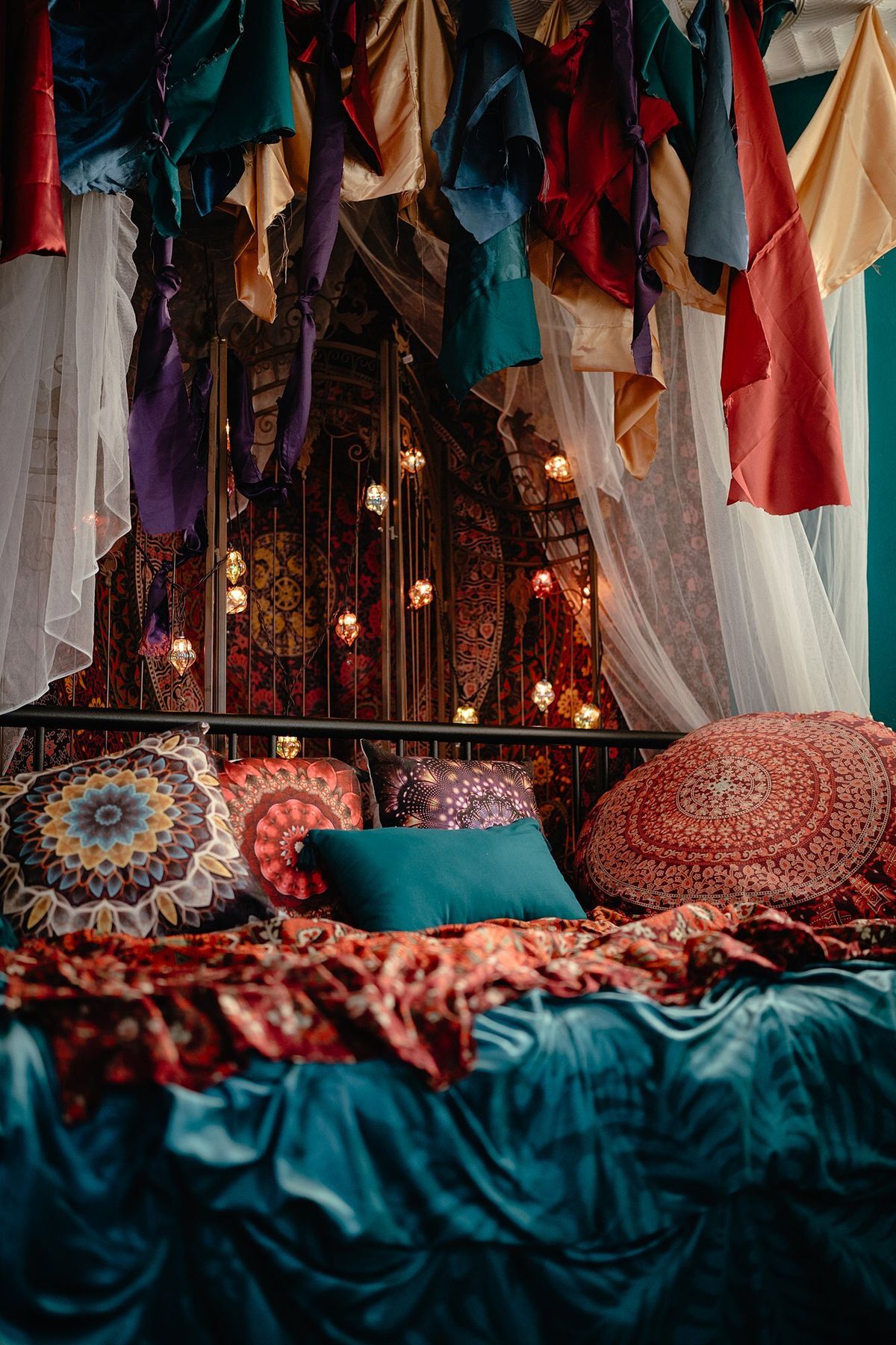 Boho room with silk canopy, lanterns, and jewel toned bedding at LeZandra Photography in Hampton Roads