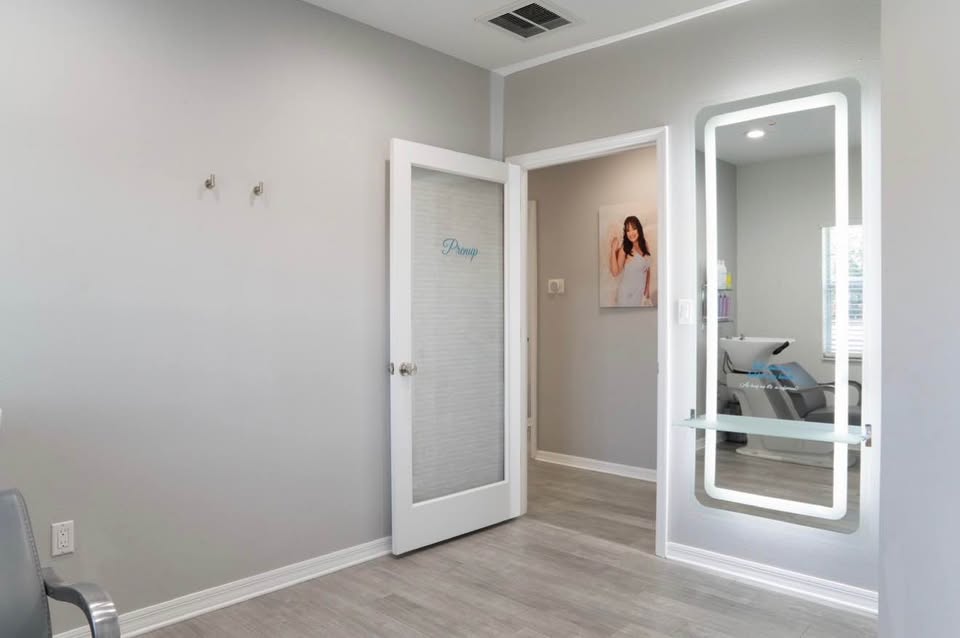 Lavish room with glass door, styling chair and mirror