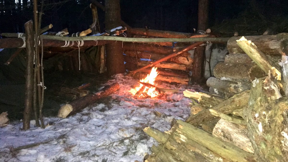A shelter and fire at dusk in the bush