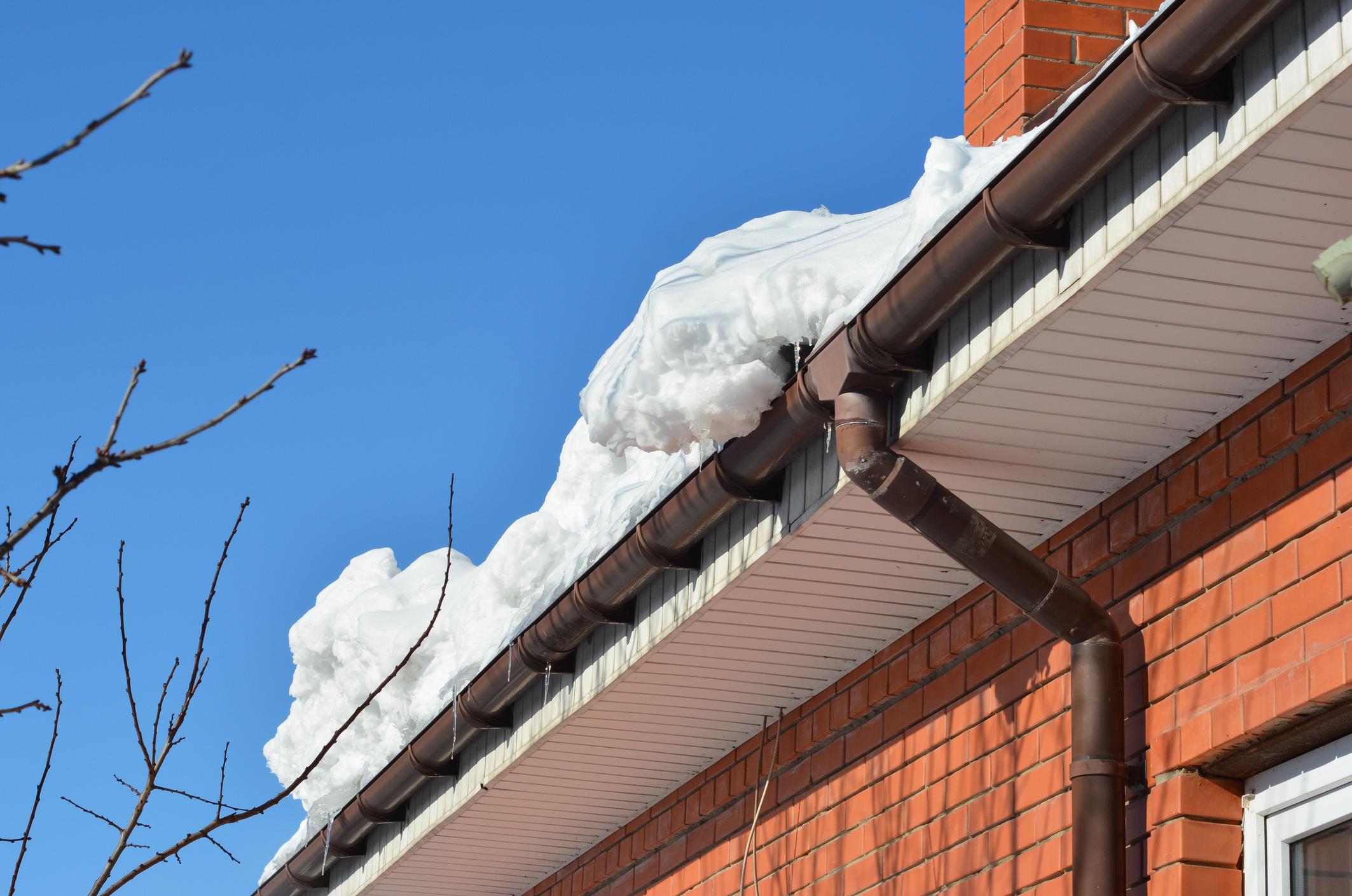ice dam formation on roof eaves Grande Prairie winter