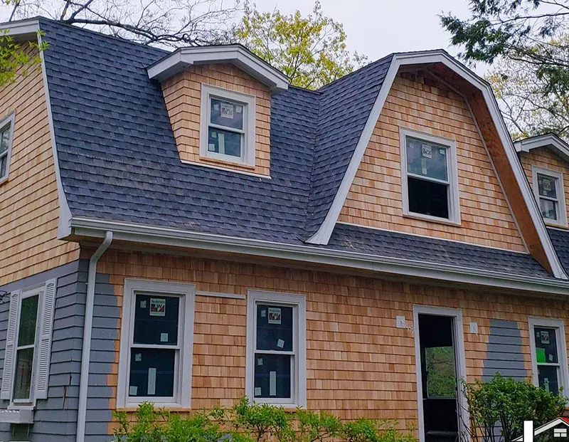 Skilled workers performing asphalt roofing installation in Randolph, MA.