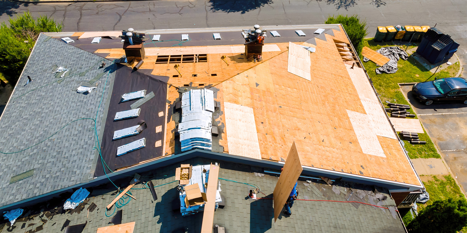 Lema Construction team performing professional roof installation in Stoughton, MA