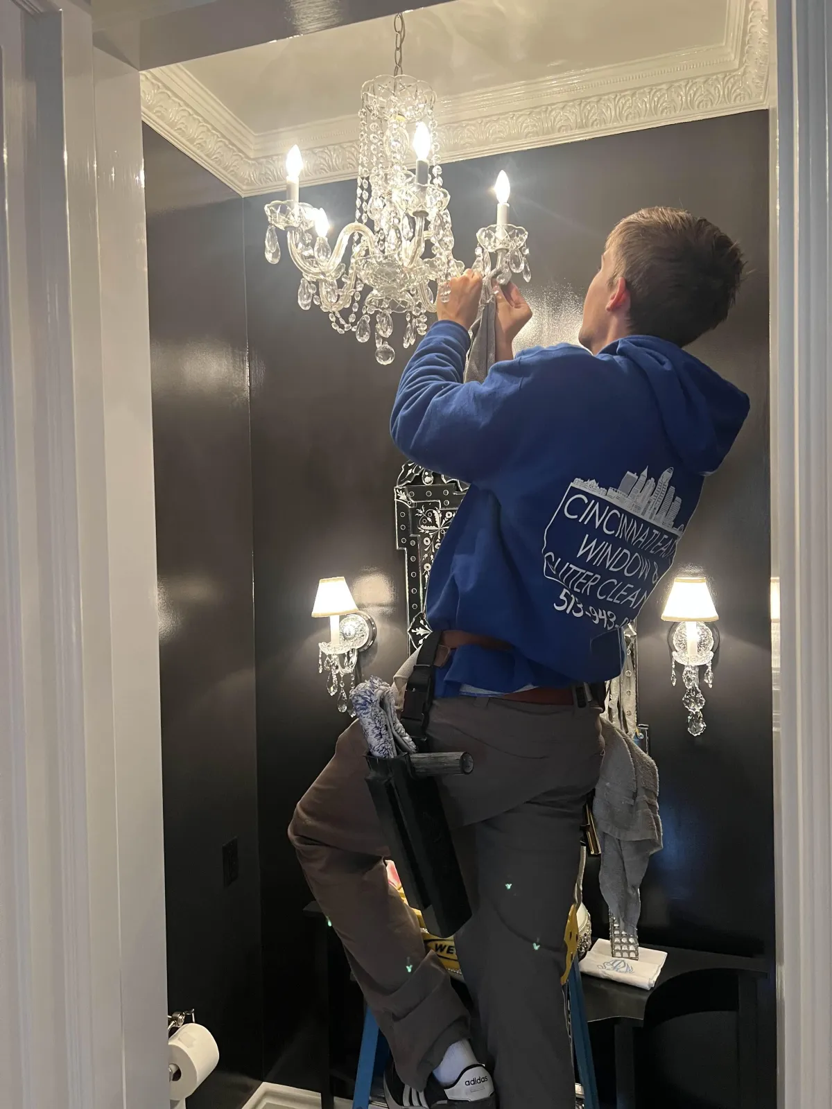 Jacob Ciminillo, owner of Cincinnati East Window & Gutter Cleaning Changing a Light Bulb