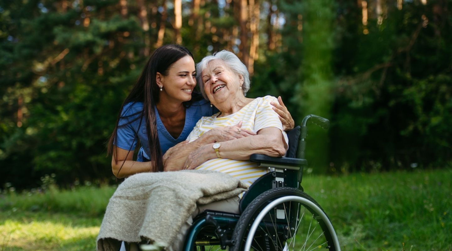 An AVet Cares caregiver comforting a senior client at home in Augusta