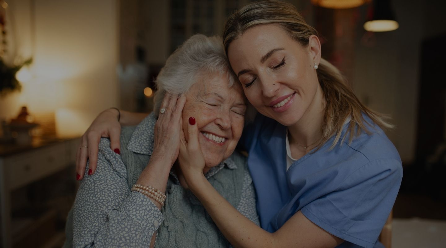 An AVet Cares caregiver supporting a senior client at home in Augusta